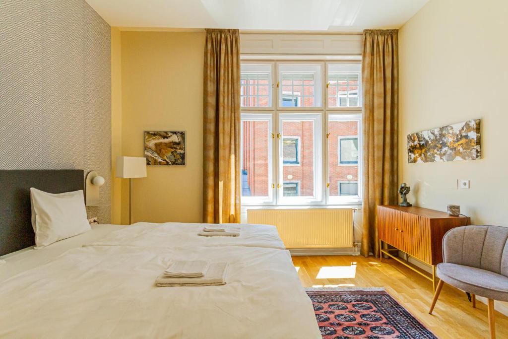 a bedroom with a large bed and a window at Bengt Apartment Kiraly Str. Luxury Suite in Budapest