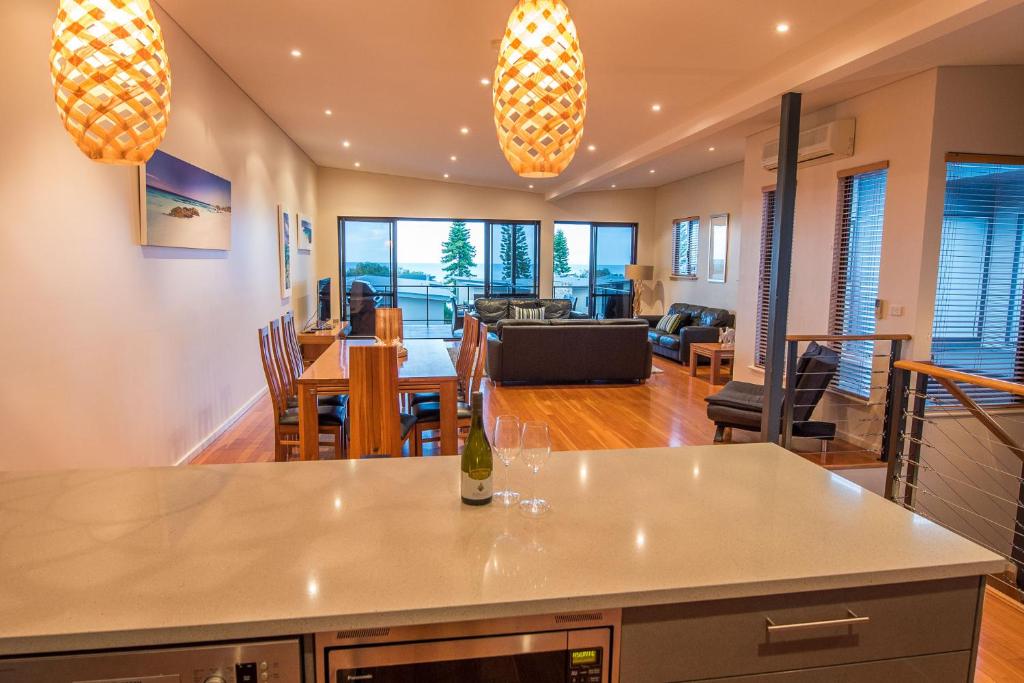 a kitchen and living room with a table and chairs at Regency Beach Club in Dunsborough