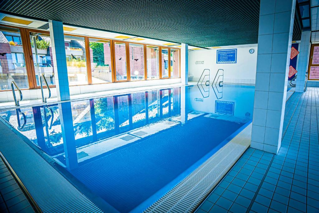 a swimming pool inside of a building with a swimming pool at Natur tanken im Schwarzwald in Sasbachwalden
