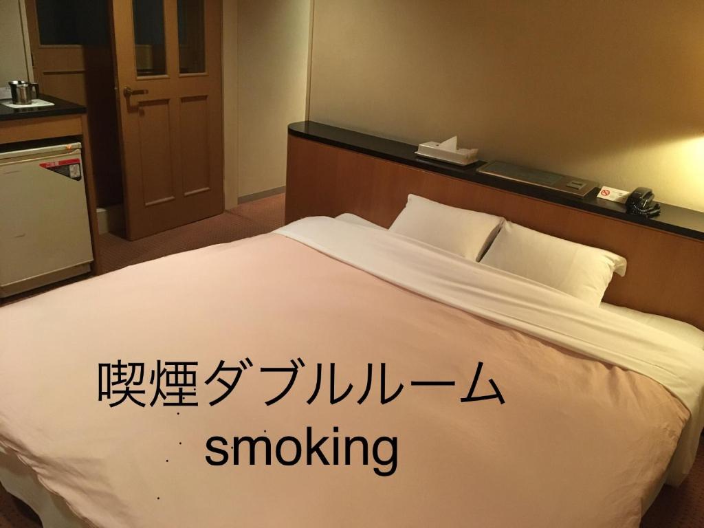 Postel nebo postele na pokoji v ubytování Hotel Noel