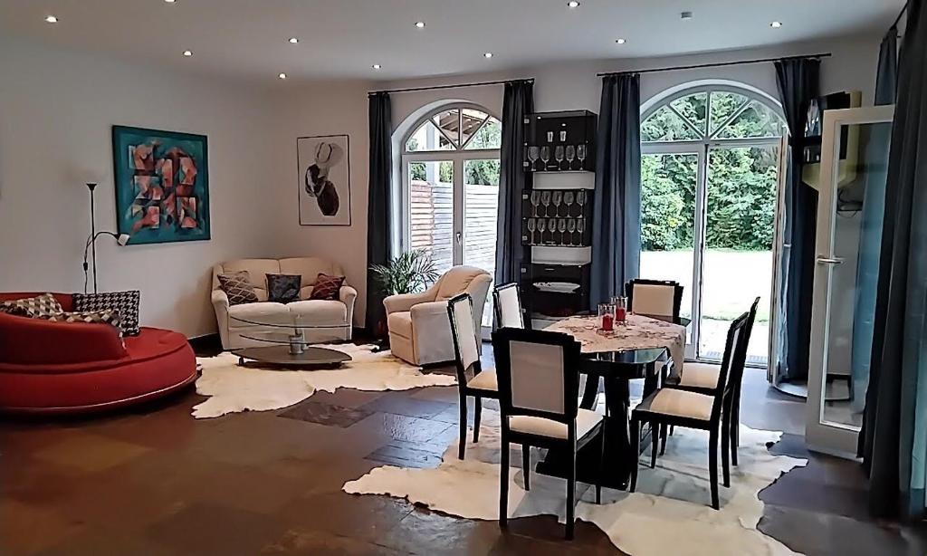 a living room with a table and chairs at ciao-aschau Haus Beate in Frasdorf