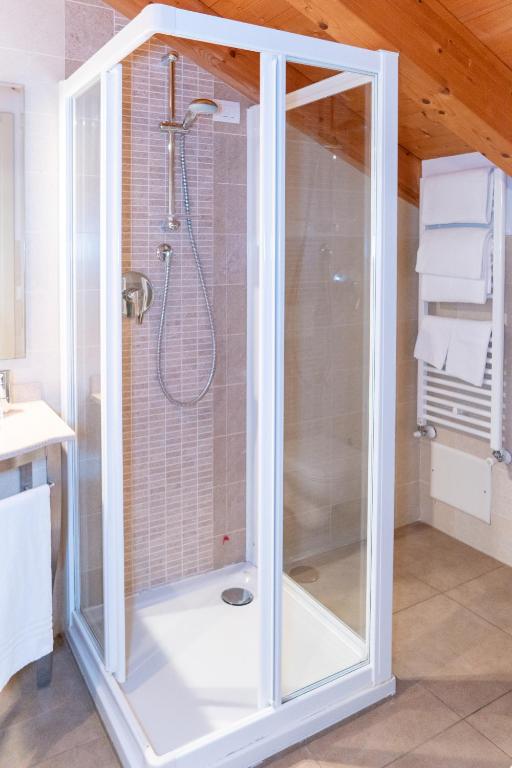 a shower with a glass door in a bathroom at Hotel Autoespresso Venice - Atika & Atif in Marghera