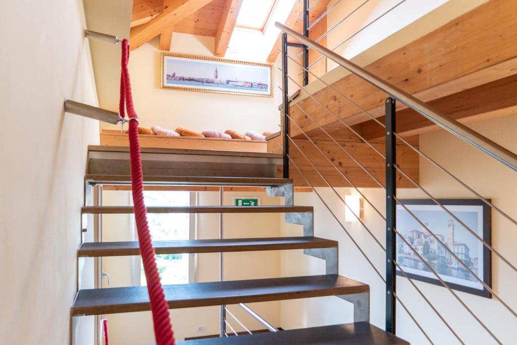 a staircase with a red rope in a house at Hotel Autoespresso Venice - Atika & Atif in Marghera