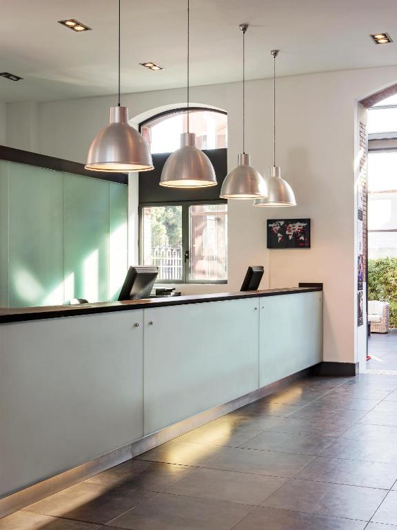 a lobby with a reception desk with two laptops at New Hotel of Marseille - Vieux Port in Marseille