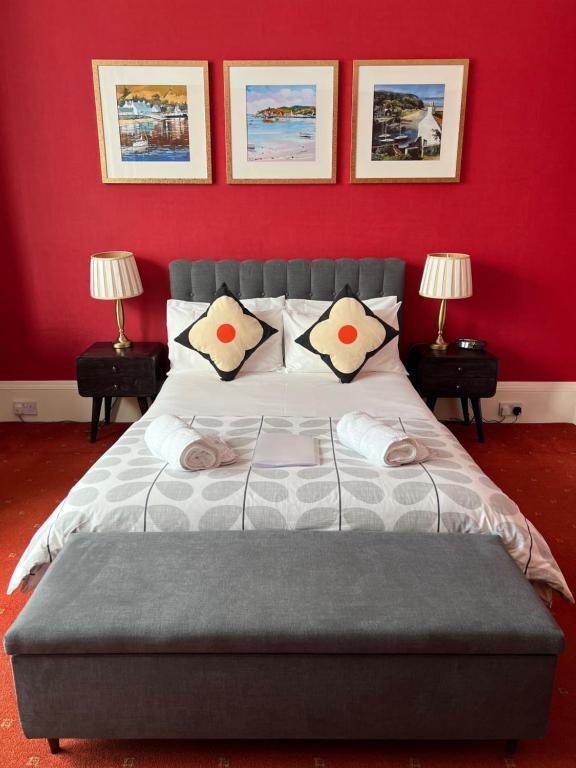 1 dormitorio con 1 cama grande y pared roja en Gladstone House, en Edimburgo