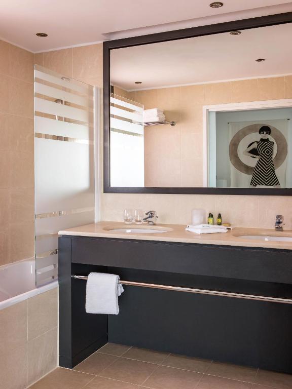 a bathroom with a sink and a mirror at New Hotel of Marseille - Vieux Port in Marseille