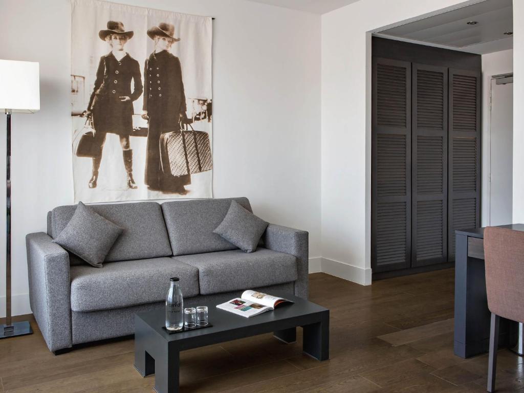 a living room with a couch and a table at New Hotel of Marseille - Vieux Port in Marseille