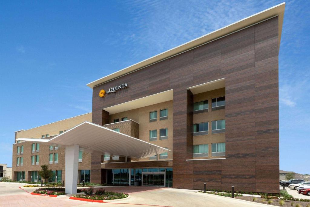 a rendering of the front of a hotel at La Quinta Inn & Suites by Wyndham Round Rock near Kalahari in Round Rock