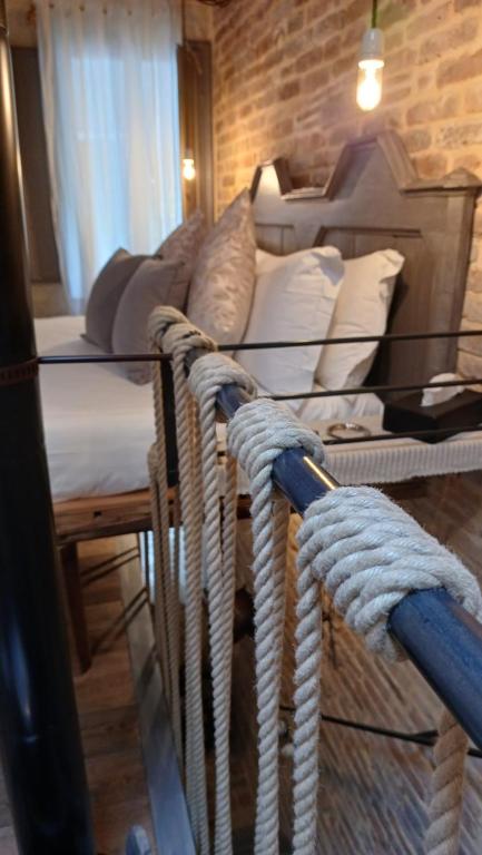 a room with a bed and a table with ropes at Dimora 421 Apartsuite in Chioggia
