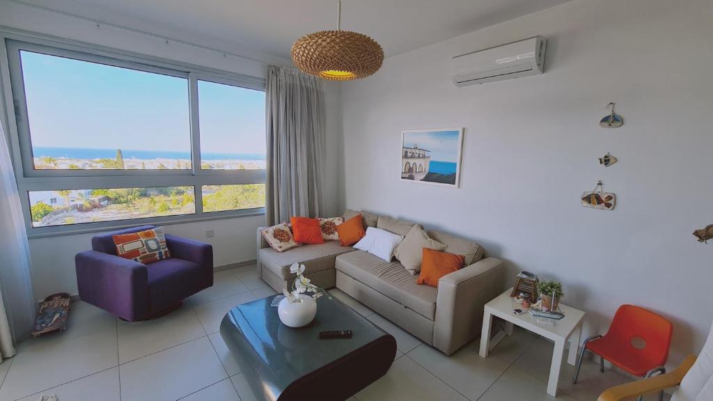 ein Wohnzimmer mit einem Sofa und einem Tisch in der Unterkunft STAY Kapparis View Apartment in Paralimni