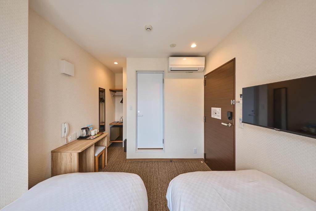 Postel nebo postele na pokoji v ubytování 若 京都河原町ホテル Waka Kyoto Kawaramachi Hotel