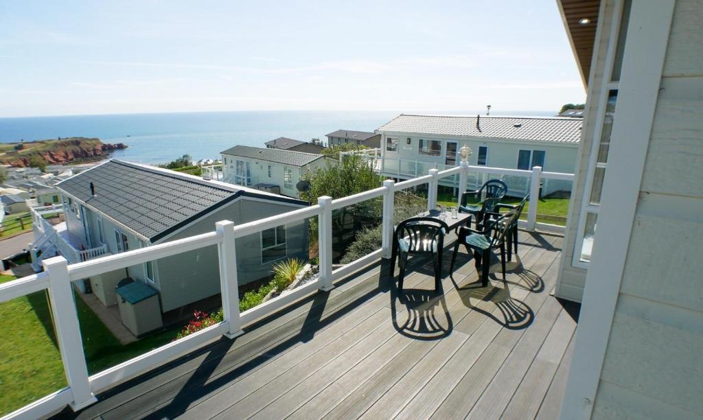 a balcony with a view of the ocean from a house at Luxury 3 Bed 2 Bath Lodge with Sea Views! in Exmouth