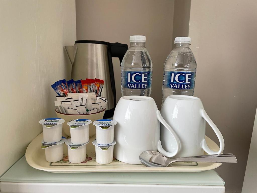 a shelf with two bottles of ice water and cups at The Sandrock in Clacton-on-Sea