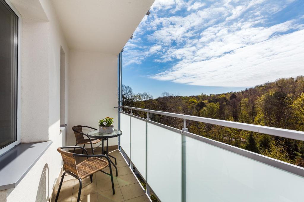 a balcony with two chairs and a table with a view at Del Mar in Gdynia