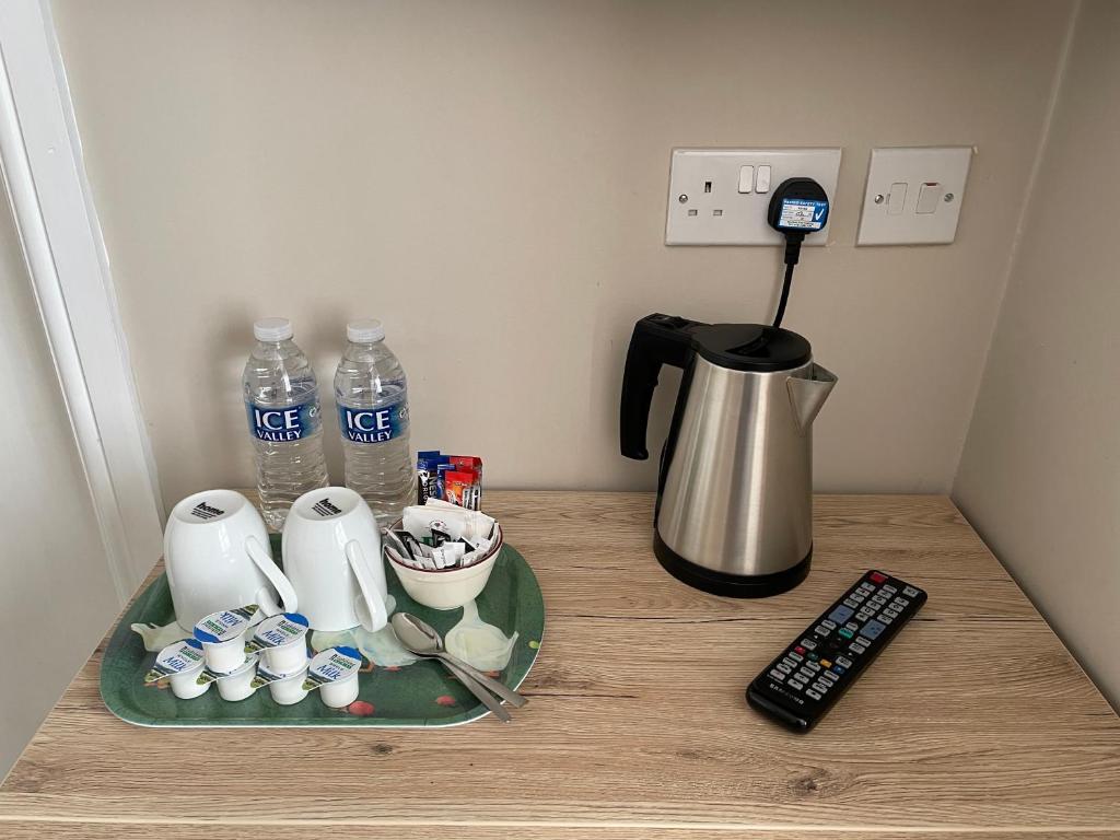 a counter top with a coffee maker and a bottle of water at The Sandrock in Clacton-on-Sea