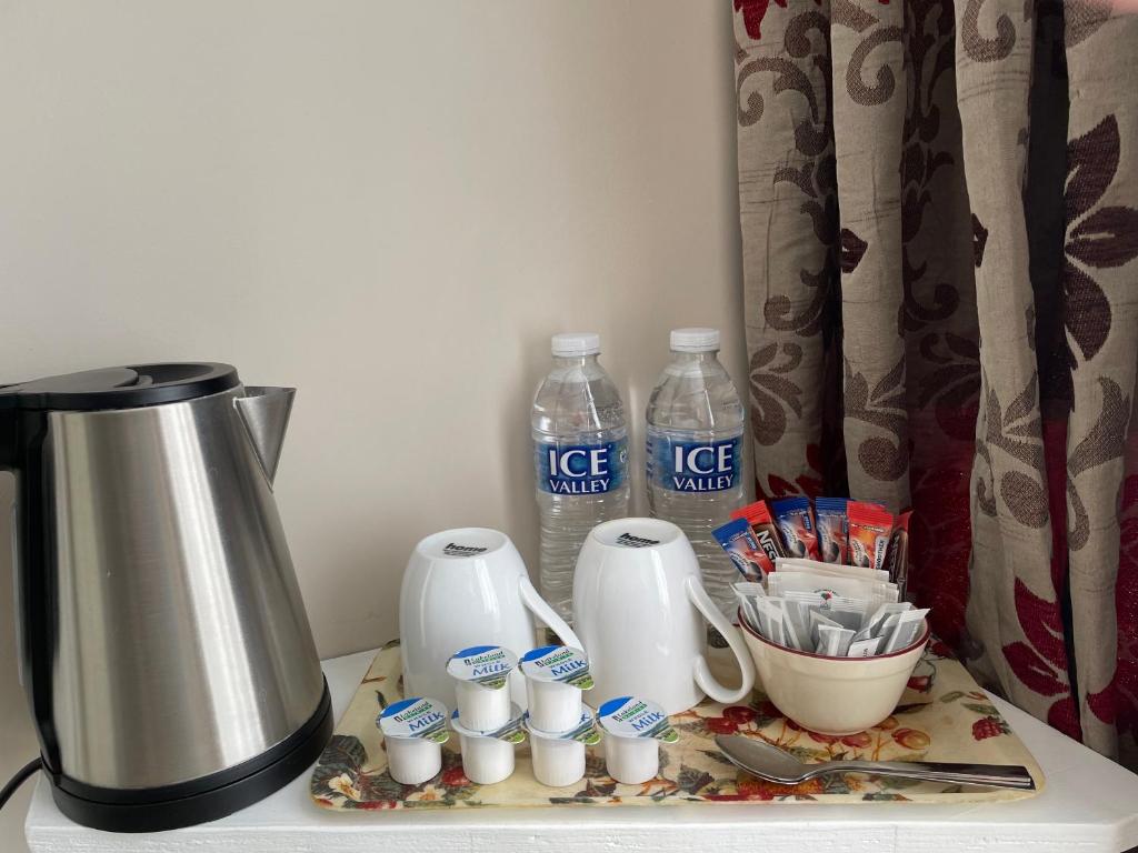 a counter with a coffee maker and bottles of water at The Sandrock in Clacton-on-Sea