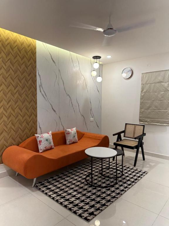 a living room with a couch and a table at Autumn suites in Hyderabad