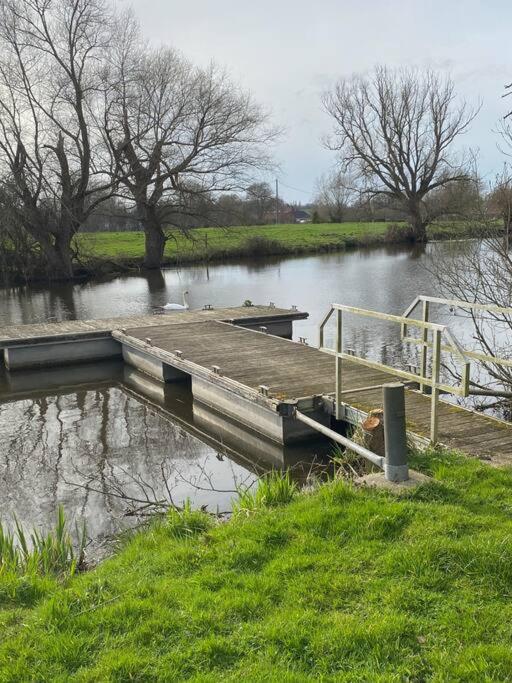 a dock in the middle of a body of water at Le Nid du Cygne in Houlle