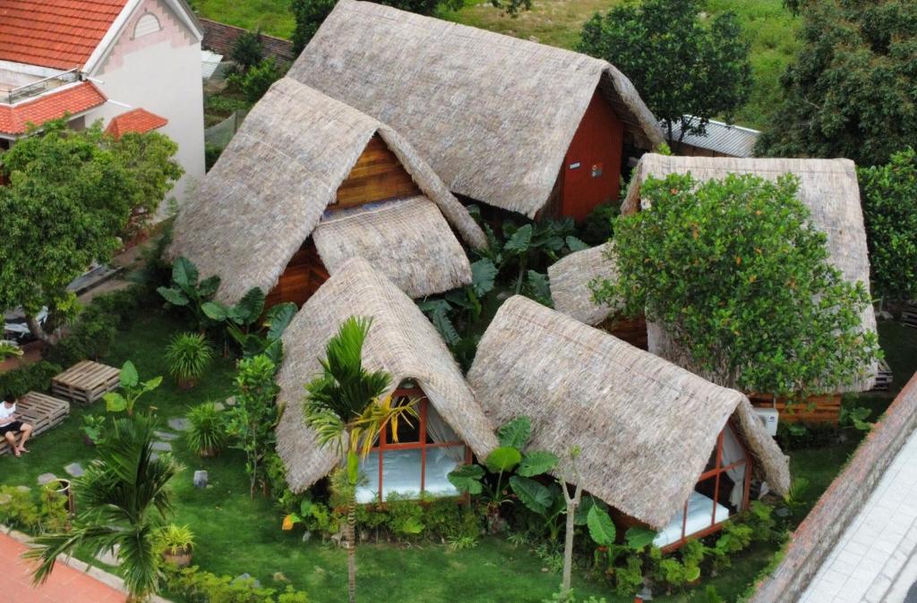 an aerial view of a house with a thatched roof at JoyStay in Cat Ba