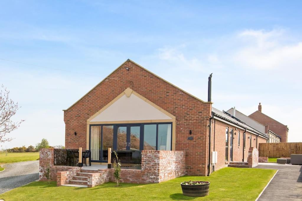 a brick building with a large window at 4 Bedroom Barn conversion in Beamish County Durham in Durham