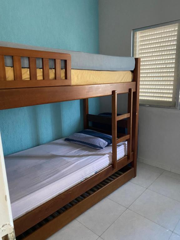 a couple of bunk beds in a room at Apartamento enseada Guarujá in Guarujá