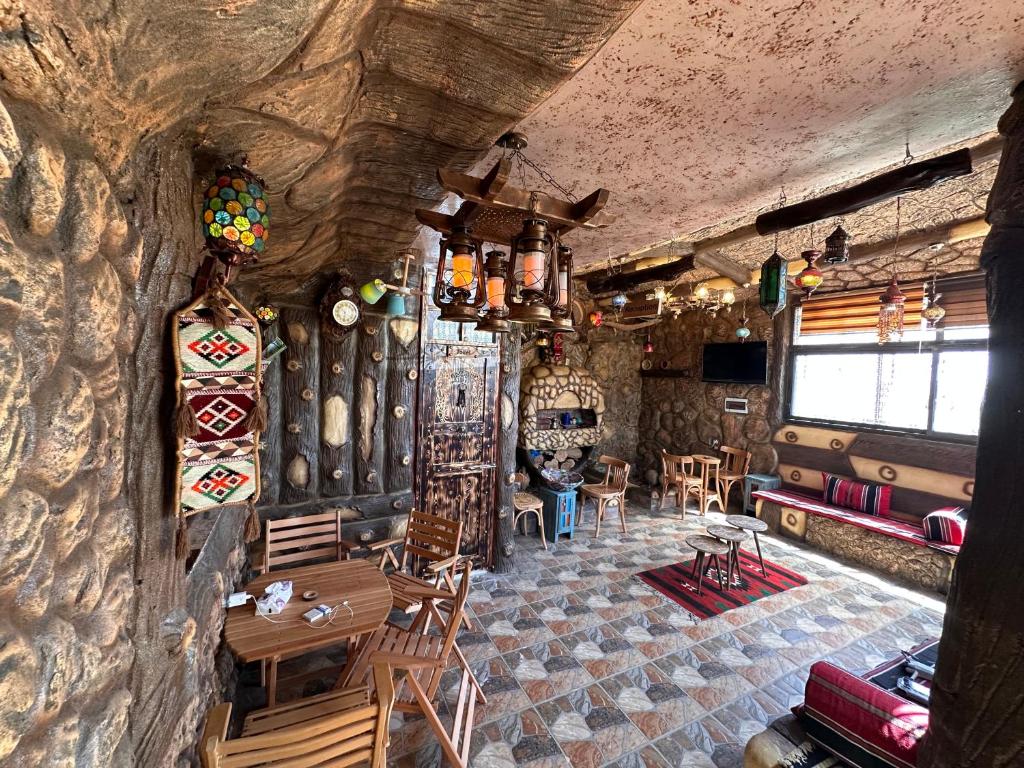 a room with tables and chairs in a building at Petra Dad Farm (PDF) in Umm Şawwānah