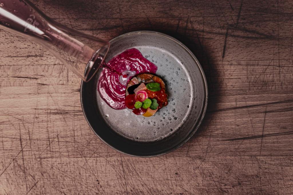 a bowl of food sitting on top of a table at Romantik Hotel Gasthaus Rottner in Nuremberg