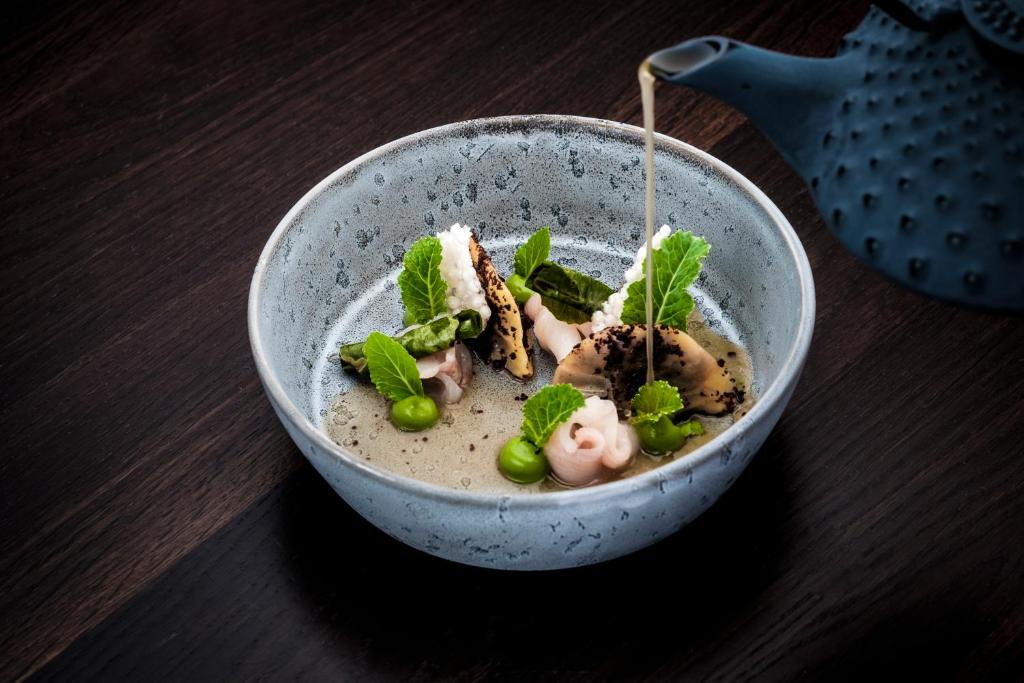 a bowl of food sitting on a table at Romantik Hotel Gasthaus Rottner in Nuremberg