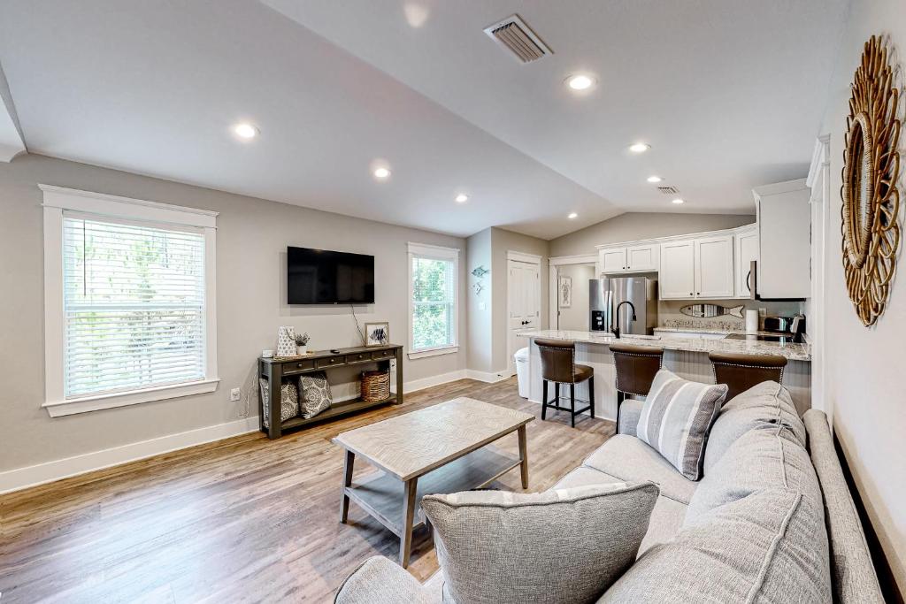 a living room with a couch and a table at Beach Cottage in Dauphin Island