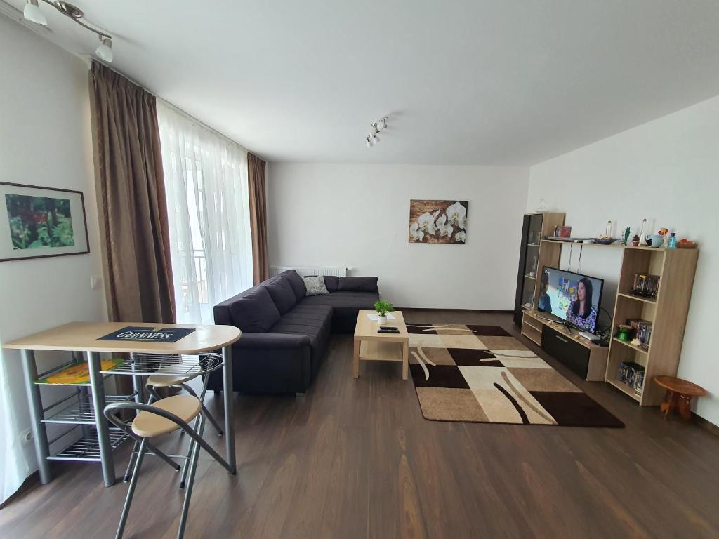 a living room with a couch and a table at Park West Apartment - Free Parking in Budapest