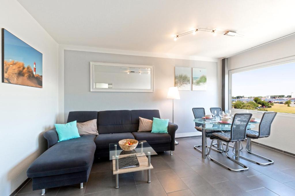 a living room with a couch and a table at Burgtiefe Südstrand "Seestern" in Fehmarn