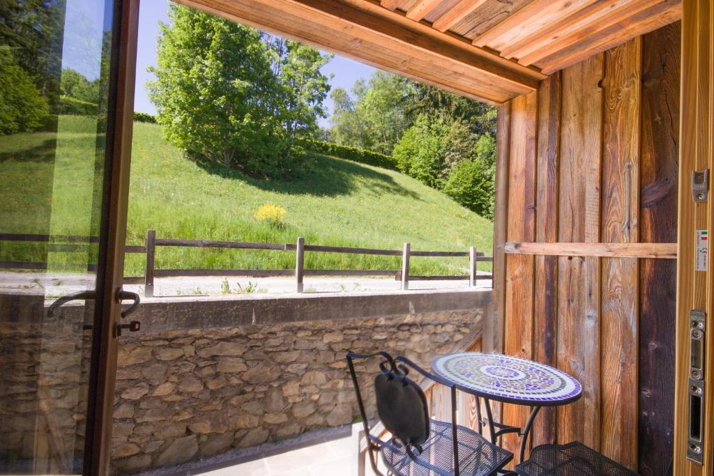 a porch with a table and a view of a field at Wanderful Life MontBlanc refuge haut de gamme in Saint-Gervais-les-Bains
