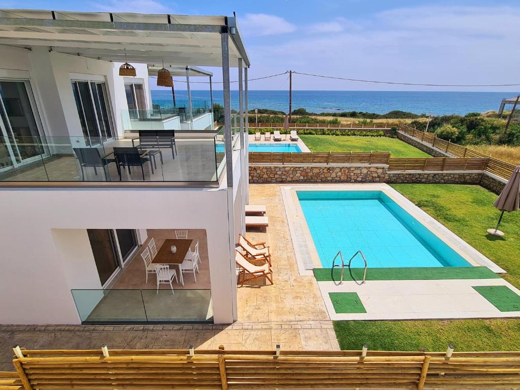 a view of a house with a swimming pool at Mythic Seaview Villas in Kiotari
