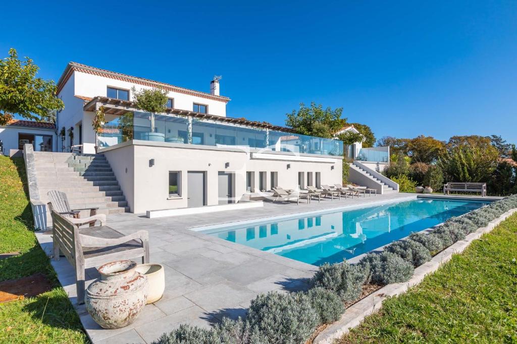 an exterior view of a house with a swimming pool at Easy Clés-Luxury Villa 16p breathtaking view in Guéthary