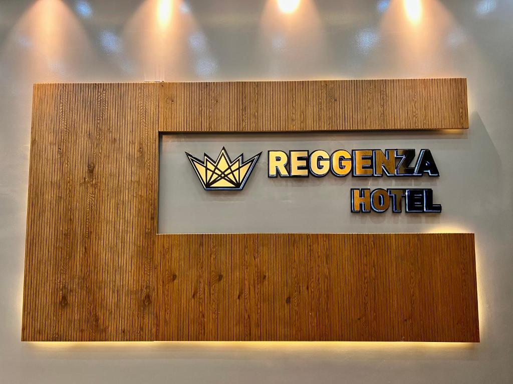 a sign for a hotel on a wall at Reggenza Hotel Downtown Ramallah in Ramallah