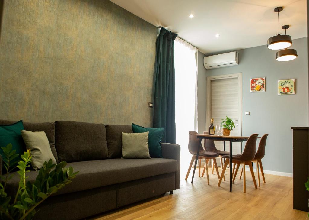 a living room with a couch and a table at Capodichino airport house in Naples