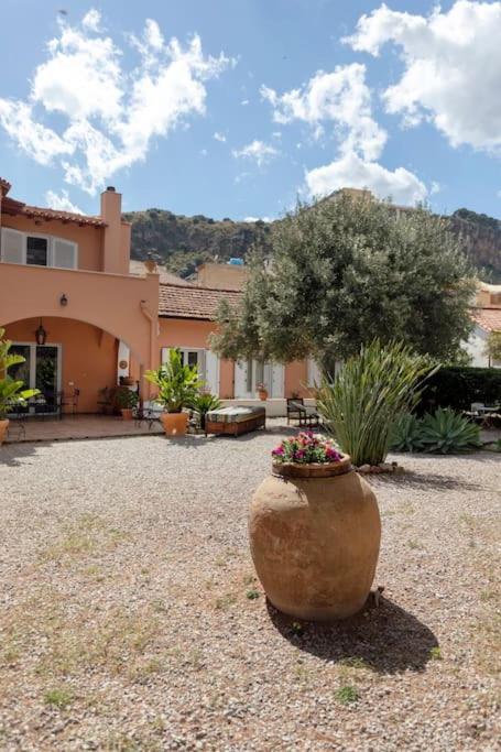 a large vase sitting in the middle of a yard at Villa Marina Sant'Elia in Santa Flavia