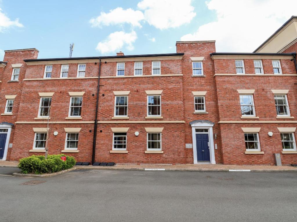 a large red brick building with a lot of windows at 122 The Old Meadow in Shrewsbury