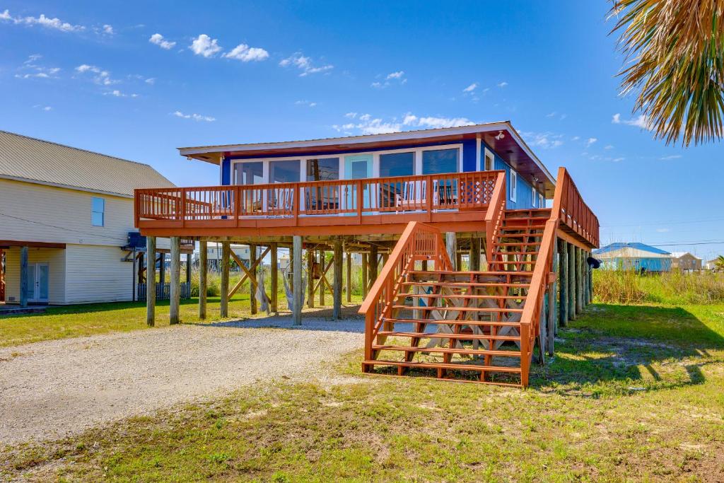 a large house with a deck on a beach at Breezy Dauphin Island Vacation Rental with Deck! in Dauphin Island