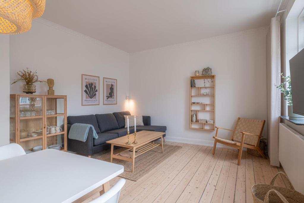 sala de estar con sofá azul y mesa en Newly renovated 1-Bed Apartment in Aalborg, en Aalborg