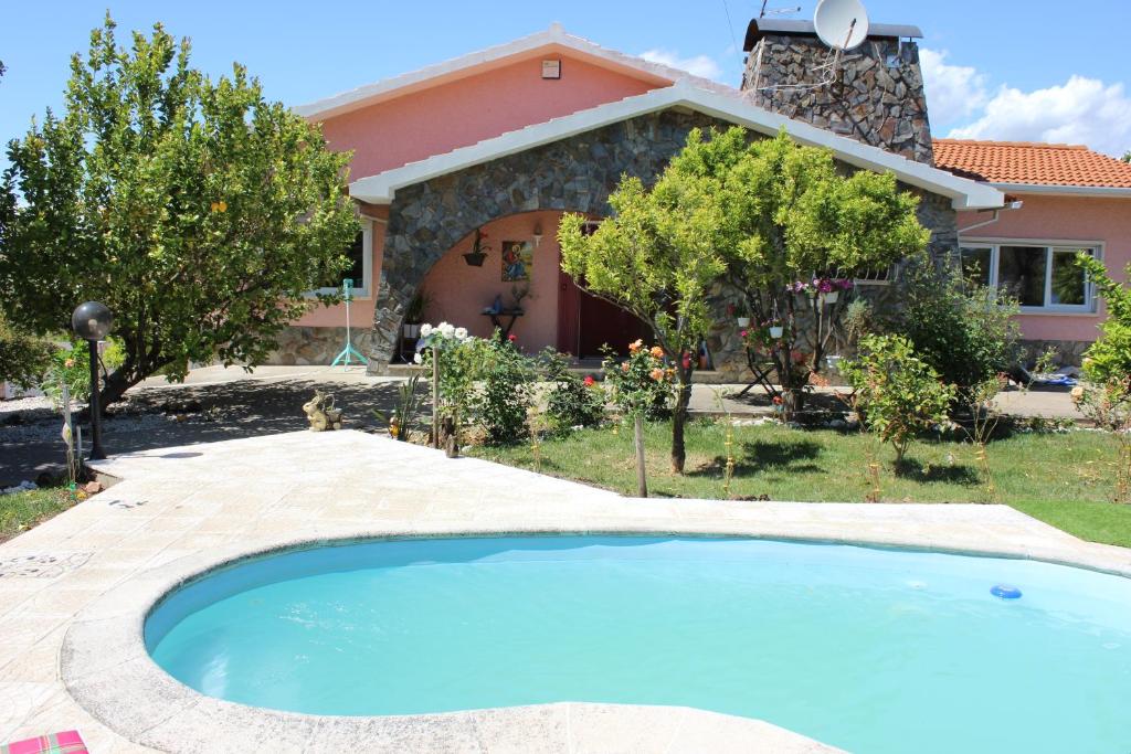 a house with a swimming pool in front of a house at Quinta de São Marcos in Fundão