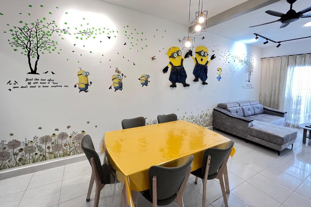 a dining room with a yellow table and a couch at FuYoke Emerald Avenue @ Brinchang in Cameron Highlands