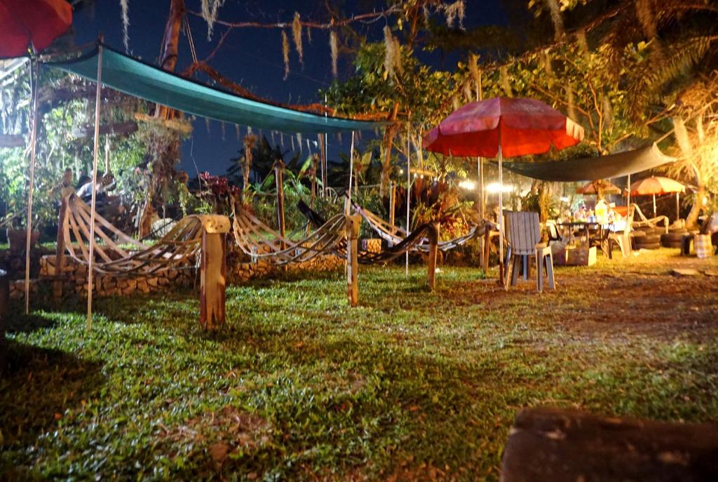 a playground at night with a hammock and umbrellas at Lavs Valley in Dapdap