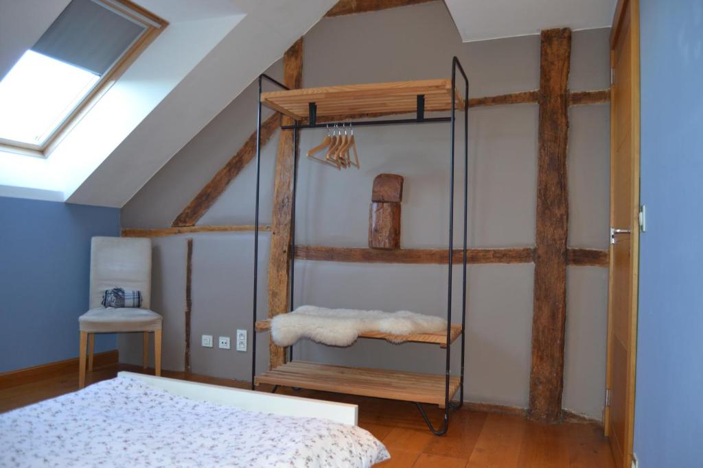 a bedroom with a bed and a glass shelf at Bidi's Lodge in Stavelot