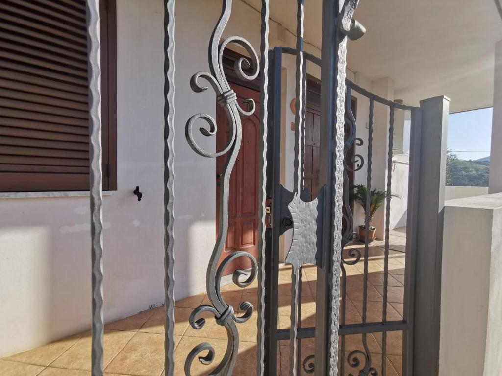 a wrought iron gate with a violin on a balcony at Appartamenti Camerota in Camerota