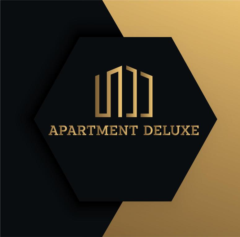 un logo negro y dorado con las palabras que entrega el apartamento en Apartment Deluxe, en Jajce