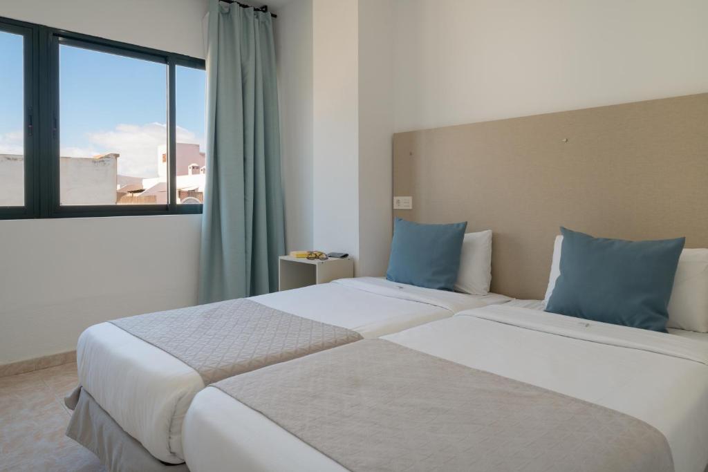 Postel nebo postele na pokoji v ubytování Sabbia Suites Arrecifeando