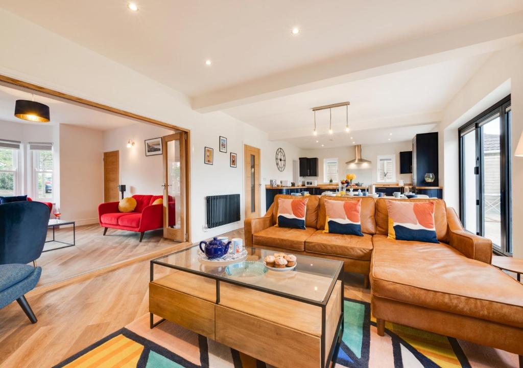 a living room with a couch and a table at Cherry Tree House in Sheringham