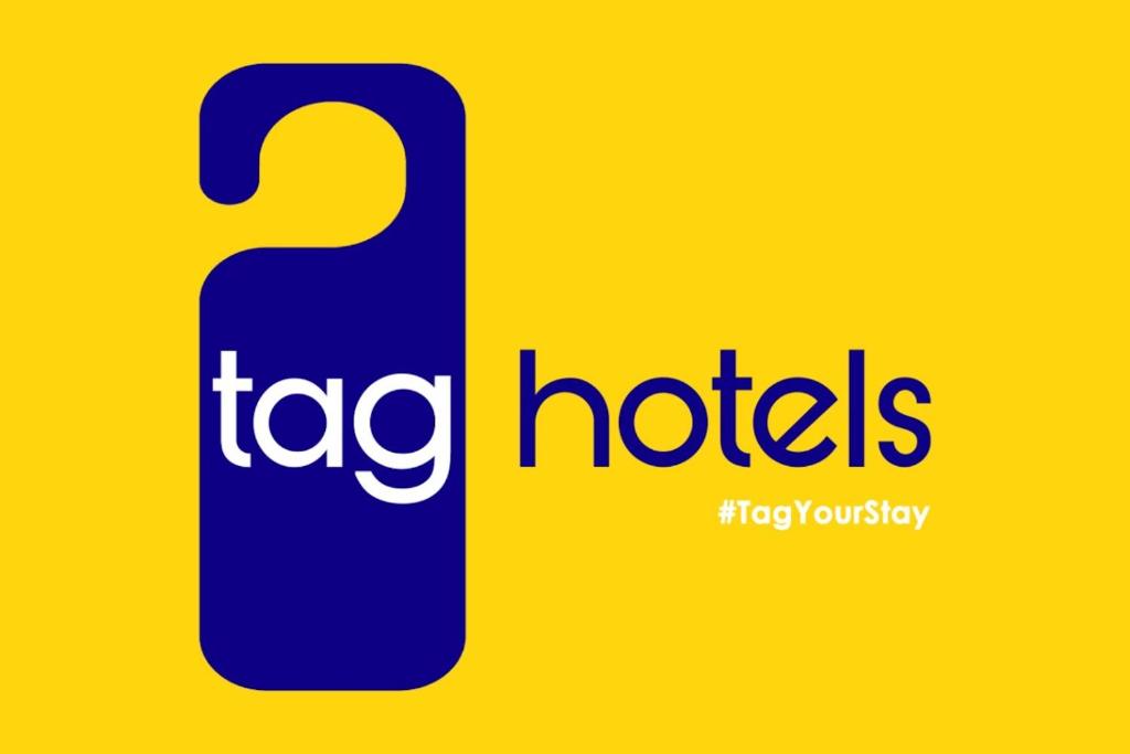 a logo for the taco hotels company at TAG HOTELS in Irugūr