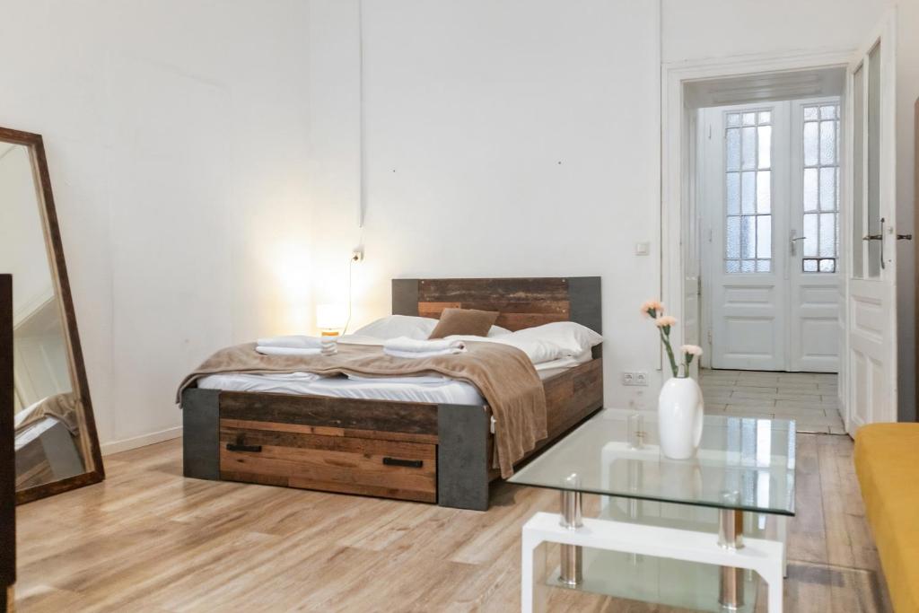 una camera con letto e tavolo in vetro di Vibrant 1BR - Ideal Long Stay Accommodation a Vienna